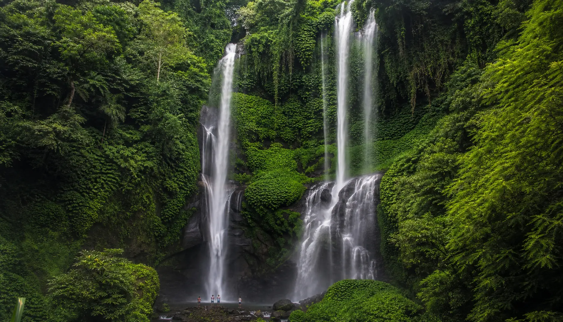 Sekumpul waterfall dropping through dense jungle in northern Bali