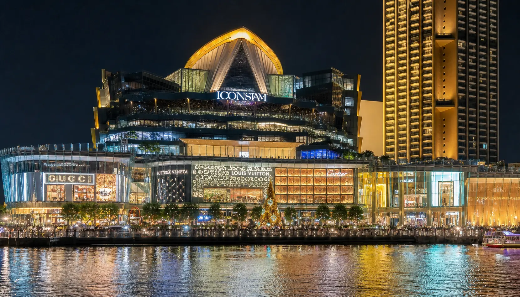 The IconSiam riverside megamall lit up on the Chao Phraya at night