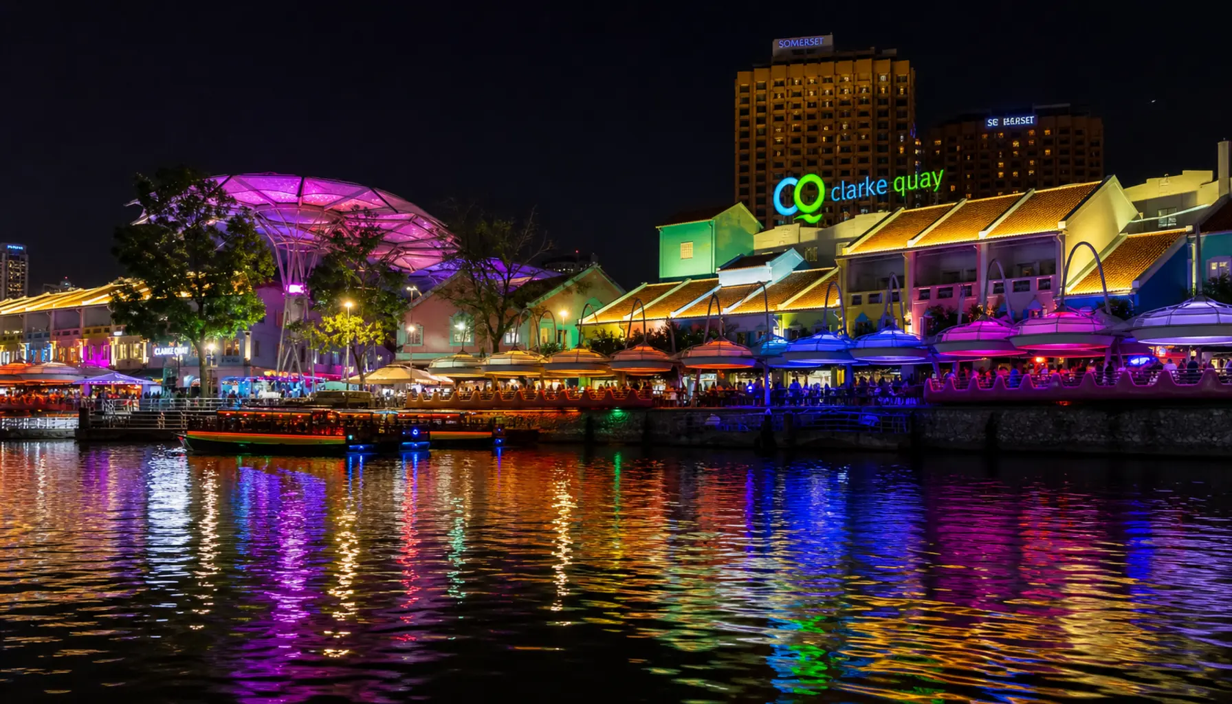 Clarke Quay's riverside bars and lights reflected in the Singapore River