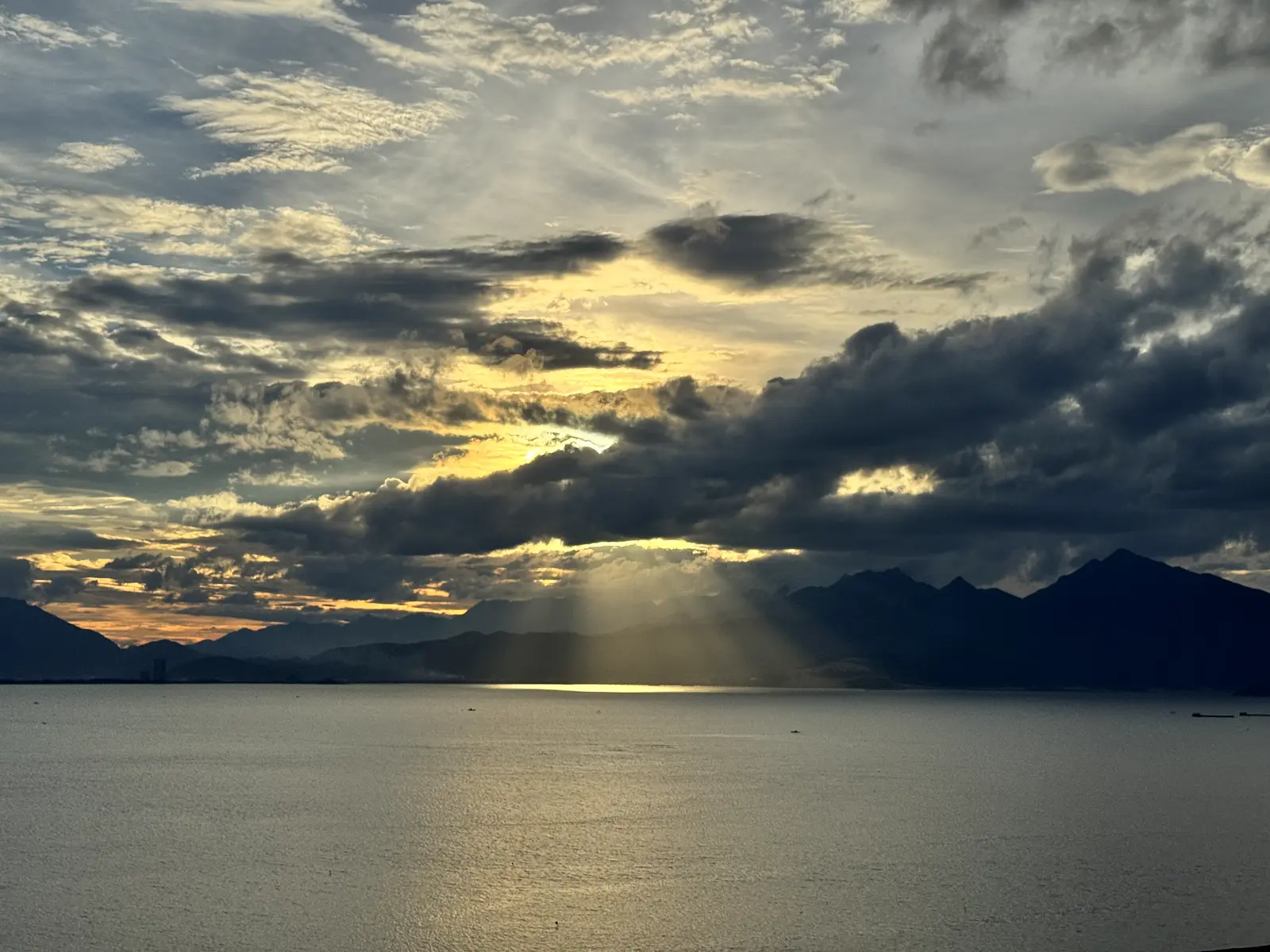 Sunset over Da Nang Bay with the Hai Van mountains in silhouette