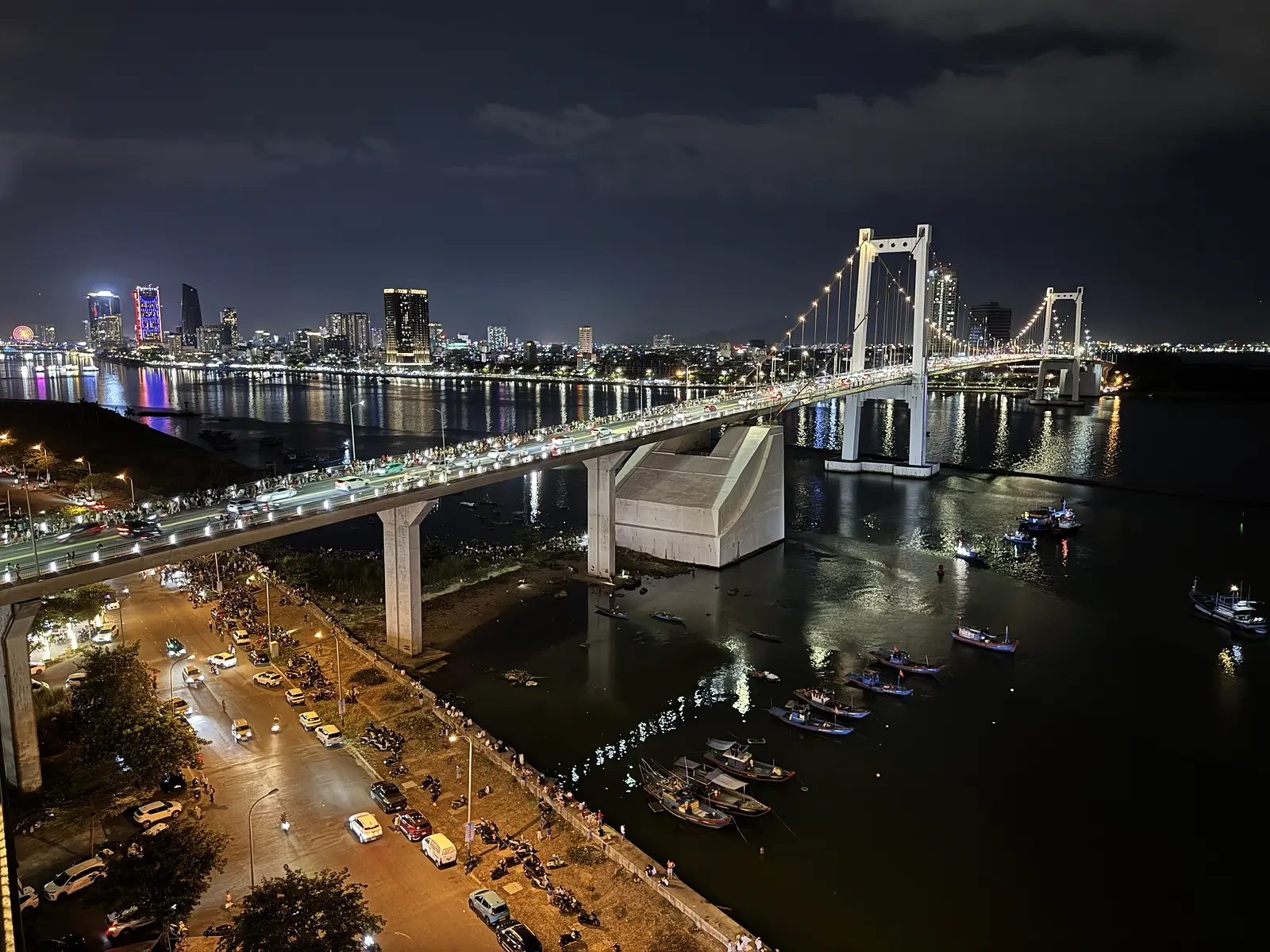Thuan Phuoc Bridge illuminated at night with the city skyline